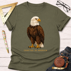 Olive green cotton t-shirt with a detailed bald eagle graphic and "Crafted In America" text.