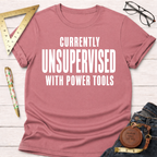 Women's funny woodworking graphic tee shirt for female woodworkers, makers, and DIY builders — Sawdust & Ponytails. Pink cotton t-shirt with "CURRENTLY UNSUPERVISED WITH POWER TOOLS" in white text.