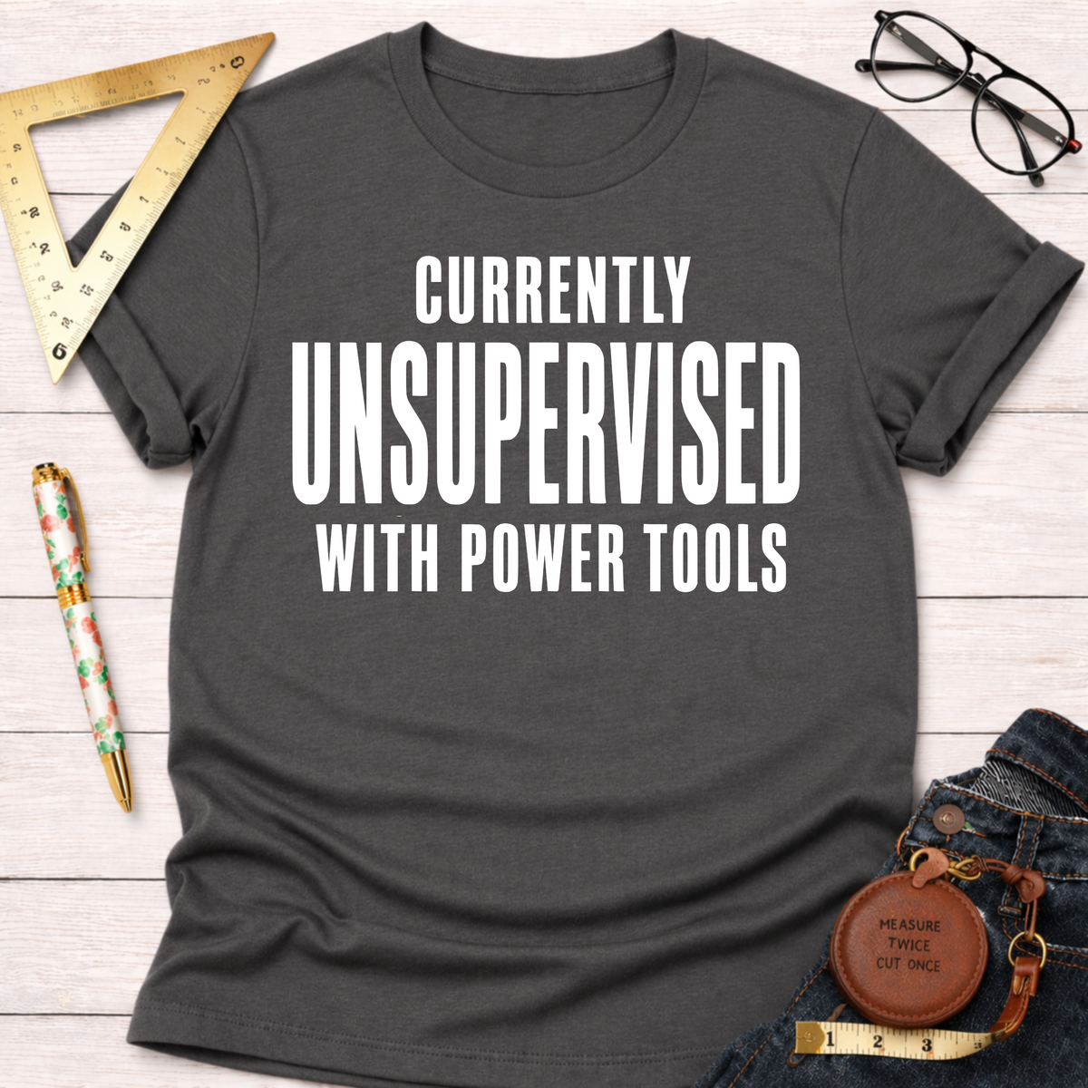 Charcoal gray cotton tee with "CURRENTLY UNSUPERVISED WITH POWER TOOLS" in white. Women's funny woodworking graphic tee shirt for female woodworkers, makers, and DIY builders — Sawdust & Ponytails