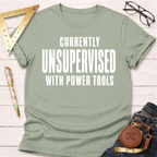 Women's funny woodworking graphic tee shirt for female woodworkers, makers, and DIY builders — Sawdust & Ponytails. Light green cotton tee with "CURRENTLY UNSUPERVISED WITH POWER TOOLS" in white text.