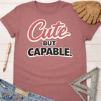 Women's funny woodworking graphic tee shirt for female woodworkers, makers, and DIY builders — Sawdust & Ponytails. Mauve cotton tee with "Cute BUT CAPABLE." graphic.