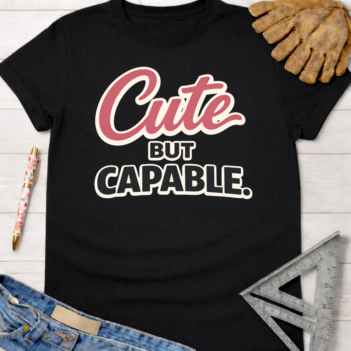 Women's funny woodworking graphic tee shirt for female woodworkers, makers, and DIY builders — Sawdust & Ponytails. Black cotton "Cute But Capable" graphic tee.