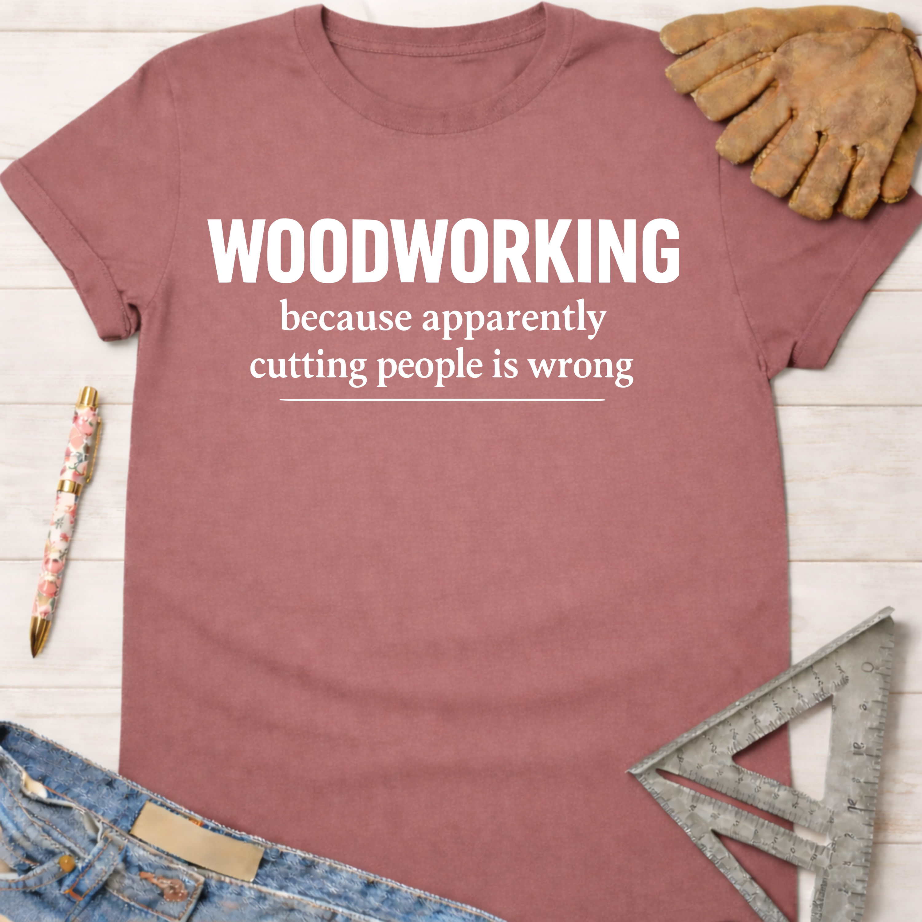 Women's funny woodworking graphic tee shirt for female woodworkers, makers, and DIY builders — Sawdust & Ponytails. Mauve cotton tee with "WOODWORKING because apparently cutting people is wrong" text.