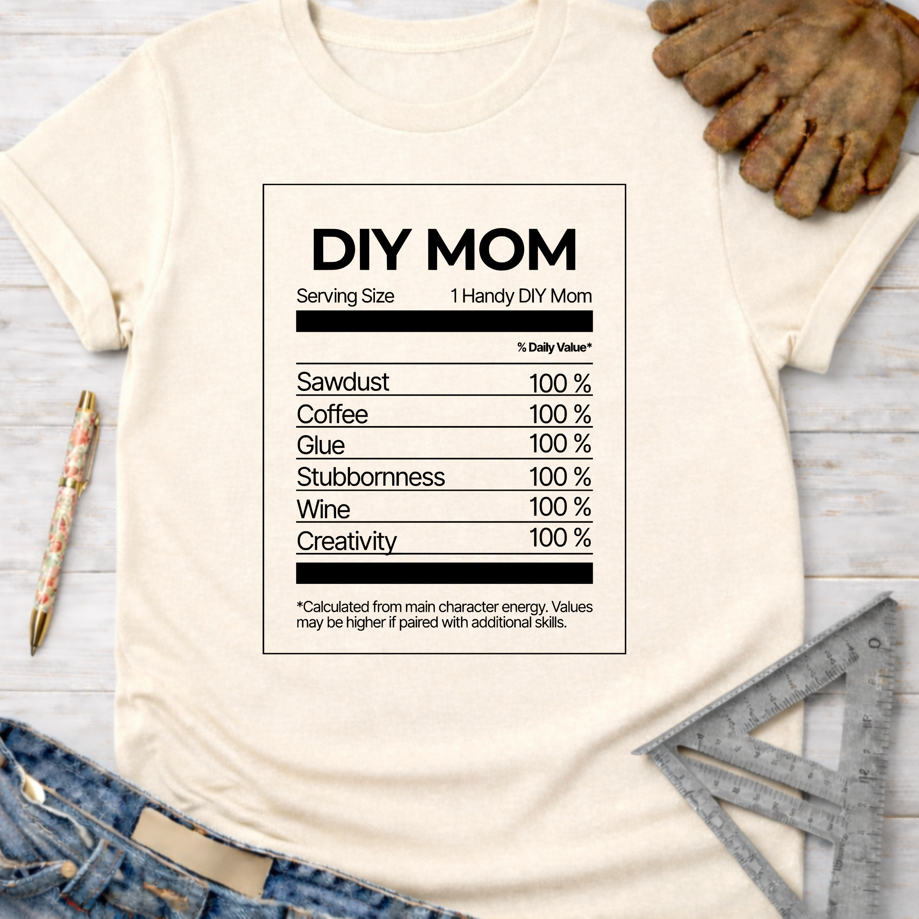 Women's funny woodworking graphic tee shirt for female woodworkers, makers, and DIY builders — Sawdust & Ponytails. Cream t-shirt with "DIY MOM Nutrition Facts" graphic.