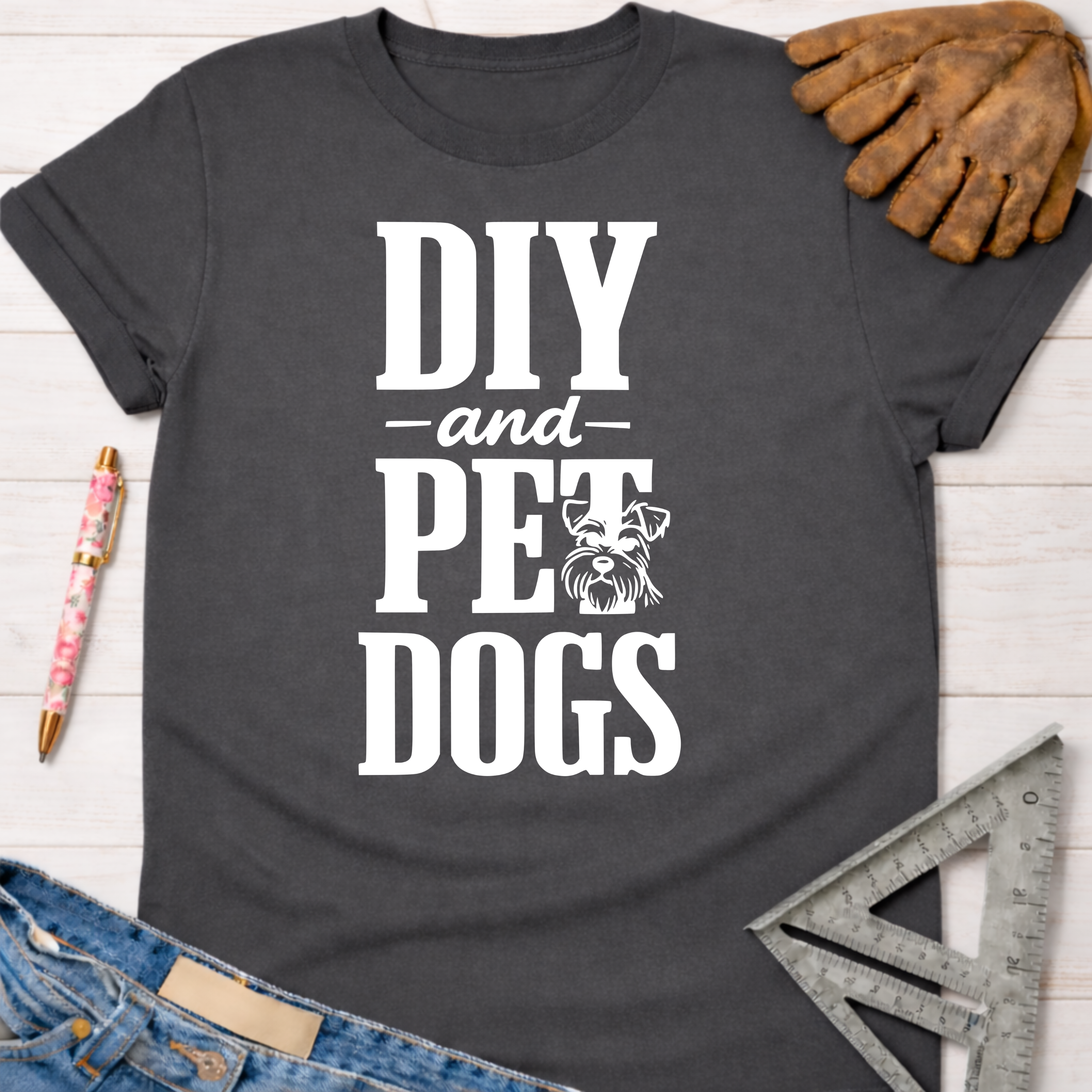 Women's funny woodworking graphic tee shirt for female woodworkers, makers, and DIY builders — Sawdust & Ponytails. Dark gray cotton tee with "DIY and Pet Dogs" text and a schnauzer graphic.