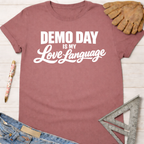 Women's funny woodworking graphic tee shirt for female woodworkers, makers, and DIY builders — Sawdust & Ponytails. Mauve cotton t-shirt with "DEMO DAY IS MY Love Language" in white text.