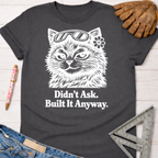 Charcoal gray "Didn't Ask. Built It Anyway." tee with a sassy cat in goggles. Women's funny woodworking graphic tee shirt for female woodworkers, makers, and DIY builders — Sawdust & Ponytails.