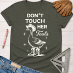 Women's funny woodworking graphic tee shirt for female woodworkers, makers, and DIY builders — Sawdust & Ponytails. Dark gray cotton tee with a white graphic of a goose in a cowboy hat and boots, with "Don't Touch Her Tools" text.