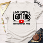 White cotton t-shirt with "Don't Worry I Got This I Watched YouTube Videos" graphic.