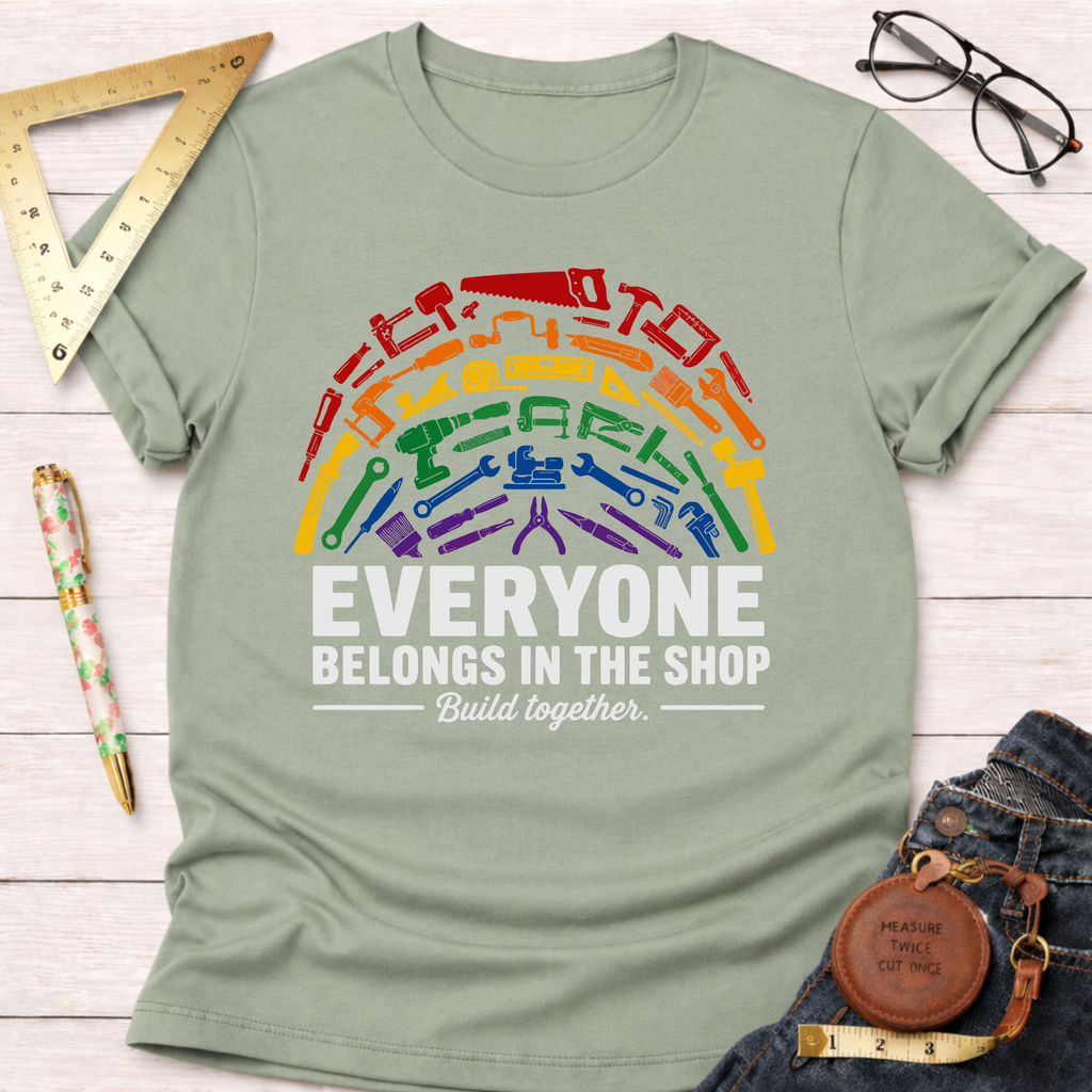 Unisex sage green t-shirt with a rainbow of diverse tools and "Everyone Belongs In The Shop" text.