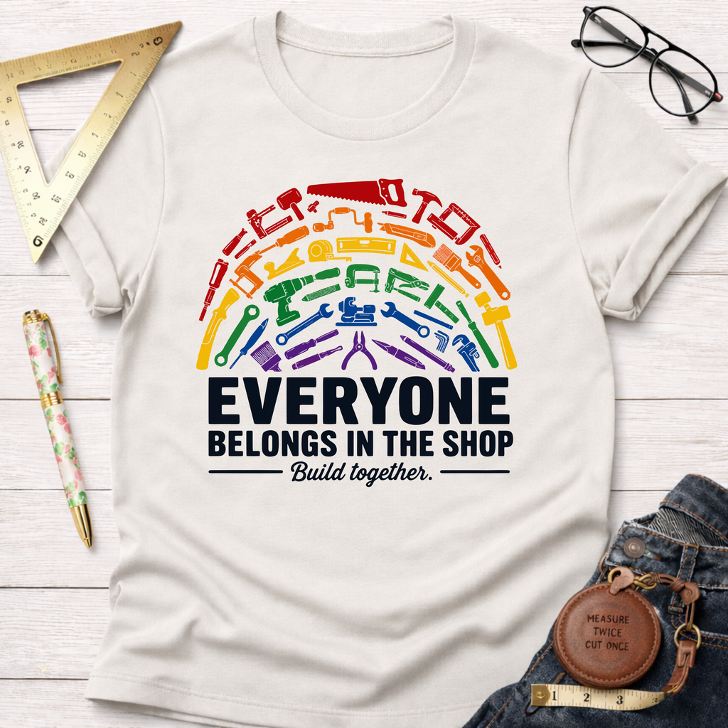 White cotton t-shirt with a rainbow arc of diverse tools and "Everyone Belongs In The Shop" text.