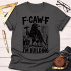 Women's funny woodworking graphic tee shirt for female woodworkers, makers, and DIY builders — Sawdust & Ponytails. Dark gray cotton tee with a black crow holding a hammer and saw, "F-CAW-F I'M BUILDING" text.