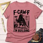 Women's funny woodworking graphic tee shirt for female woodworkers, makers, and DIY builders — Sawdust & Ponytails. Heather mauve cotton tee with a black crow holding a hammer and saw, text "F-CAW-F I'M BUILDING".