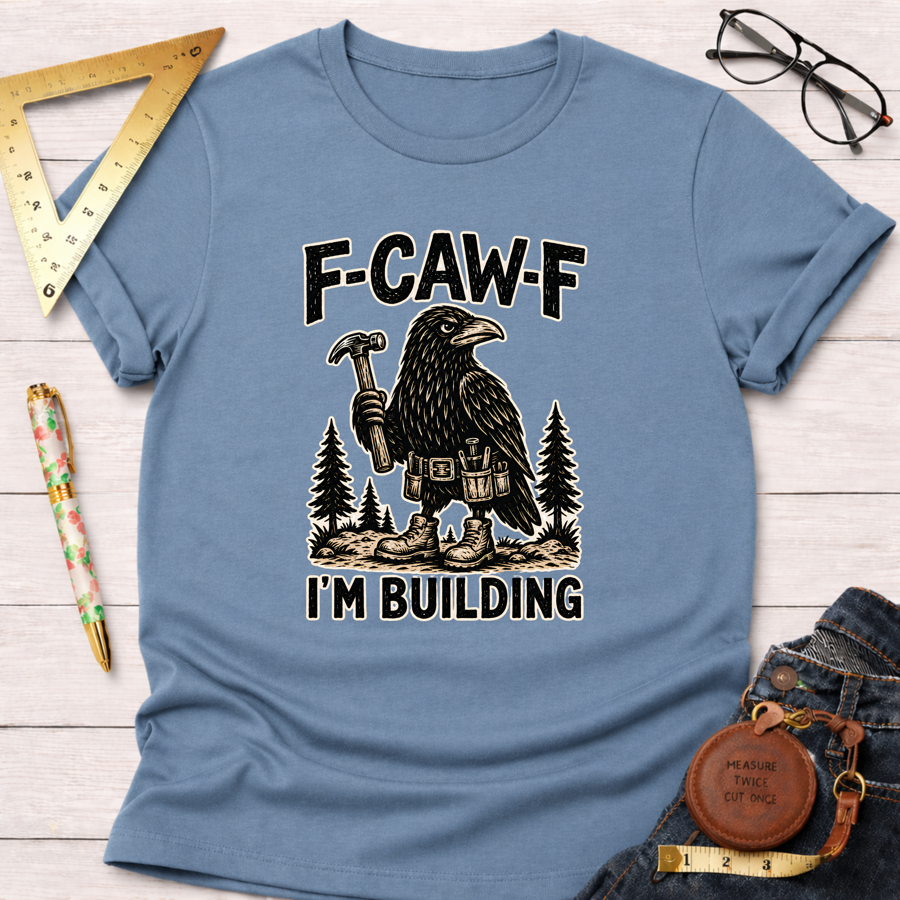 Light blue F-CAW-F, I'm Building T-shirt with a crow holding a hammer and wearing a tool belt.