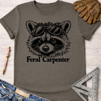 Charcoal gray Feral Carpenter t-shirt with a raccoon wearing sunglasses graphic. Women's funny woodworking graphic tee shirt for female woodworkers, makers, and DIY builders — Sawdust & Ponytails