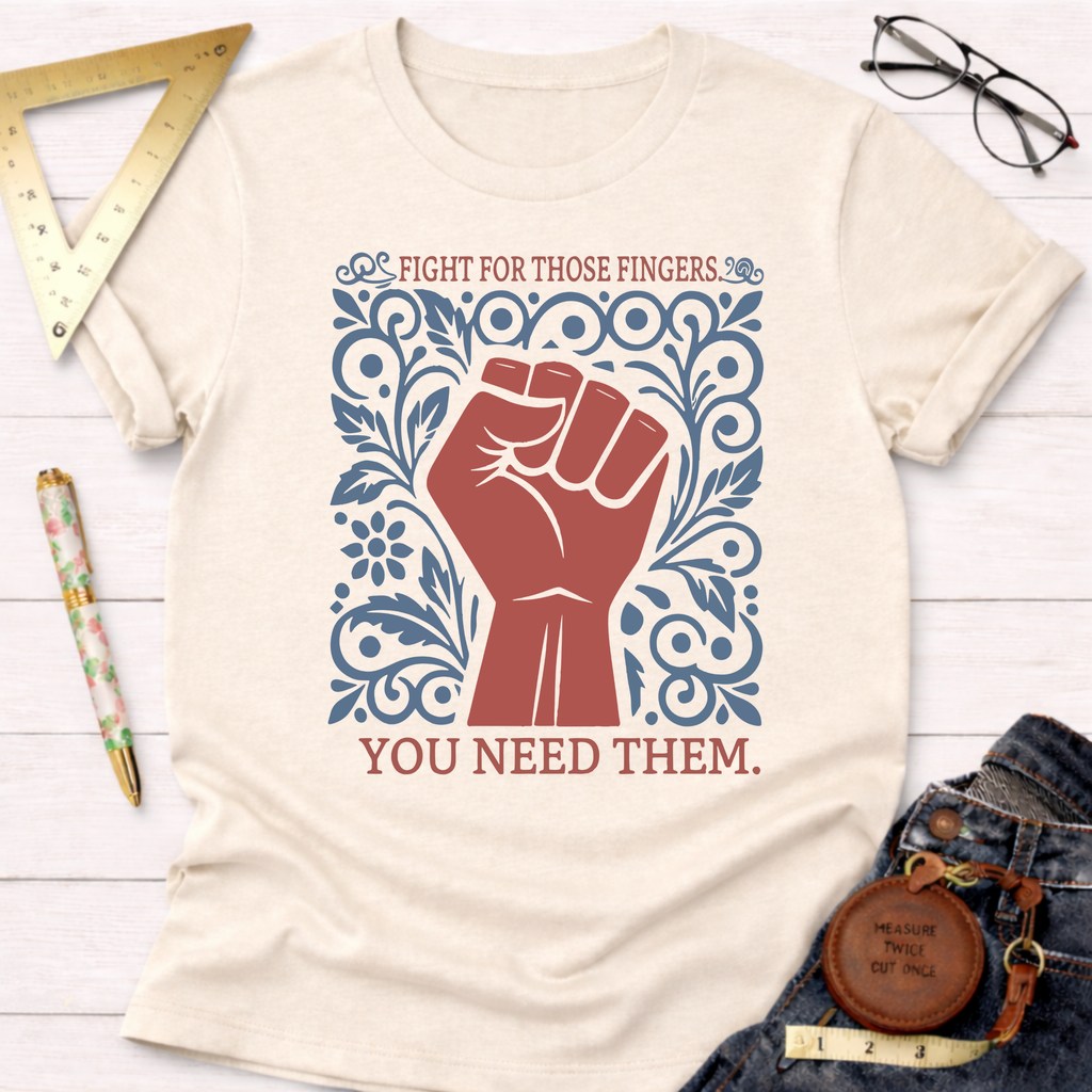 Cream t-shirt with a red fist and blue floral design, text "Fight For Those Fingers You Need Them.