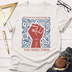 Cream cotton t-shirt with a red fist and blue floral design, "FIGHT FOR THOSE FINGERS. YOU NEED THEM." text.