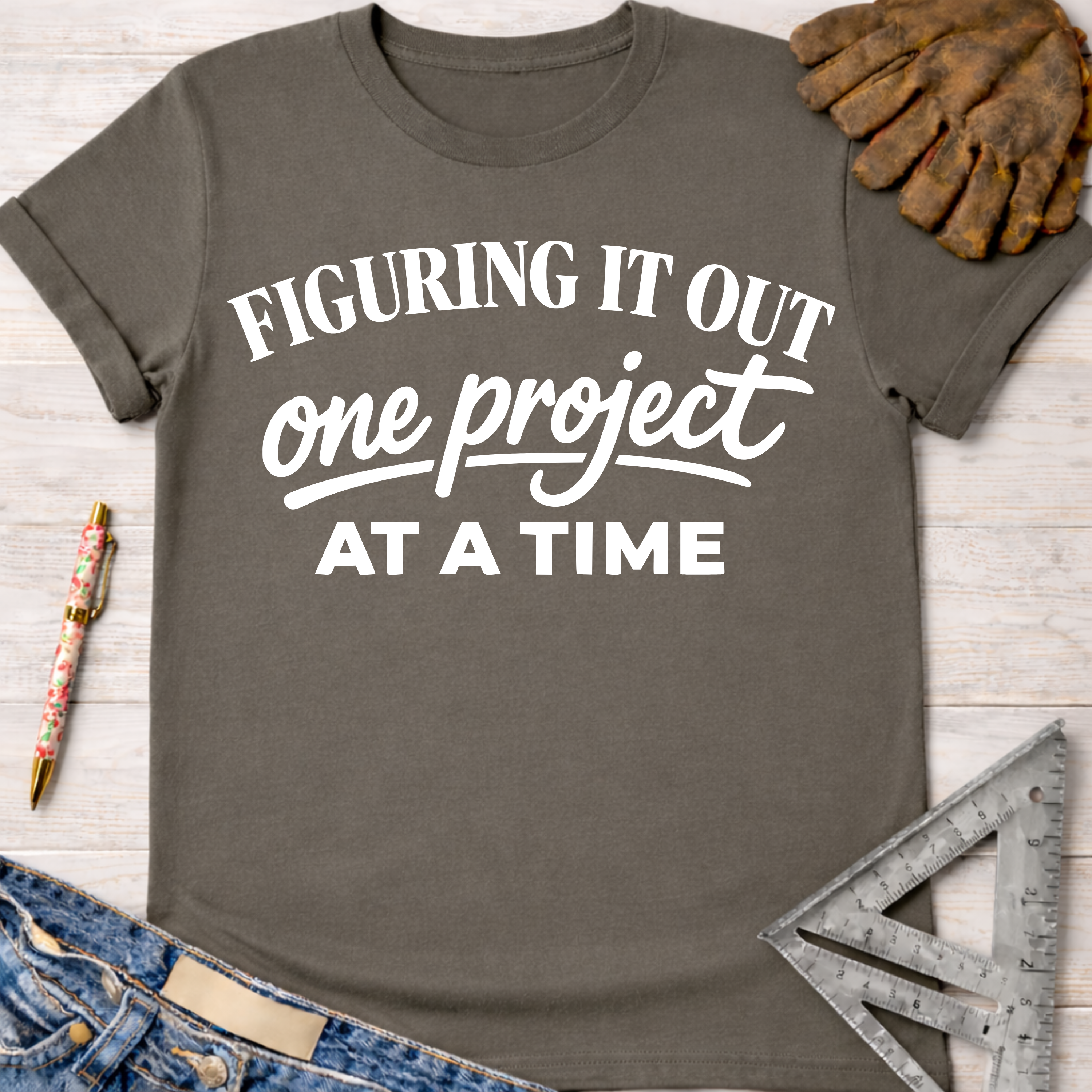 Charcoal gray "Figuring It Out One Project At A Time" women's funny woodworking graphic tee shirt for female woodworkers, makers, and DIY builders — Sawdust & Ponytails