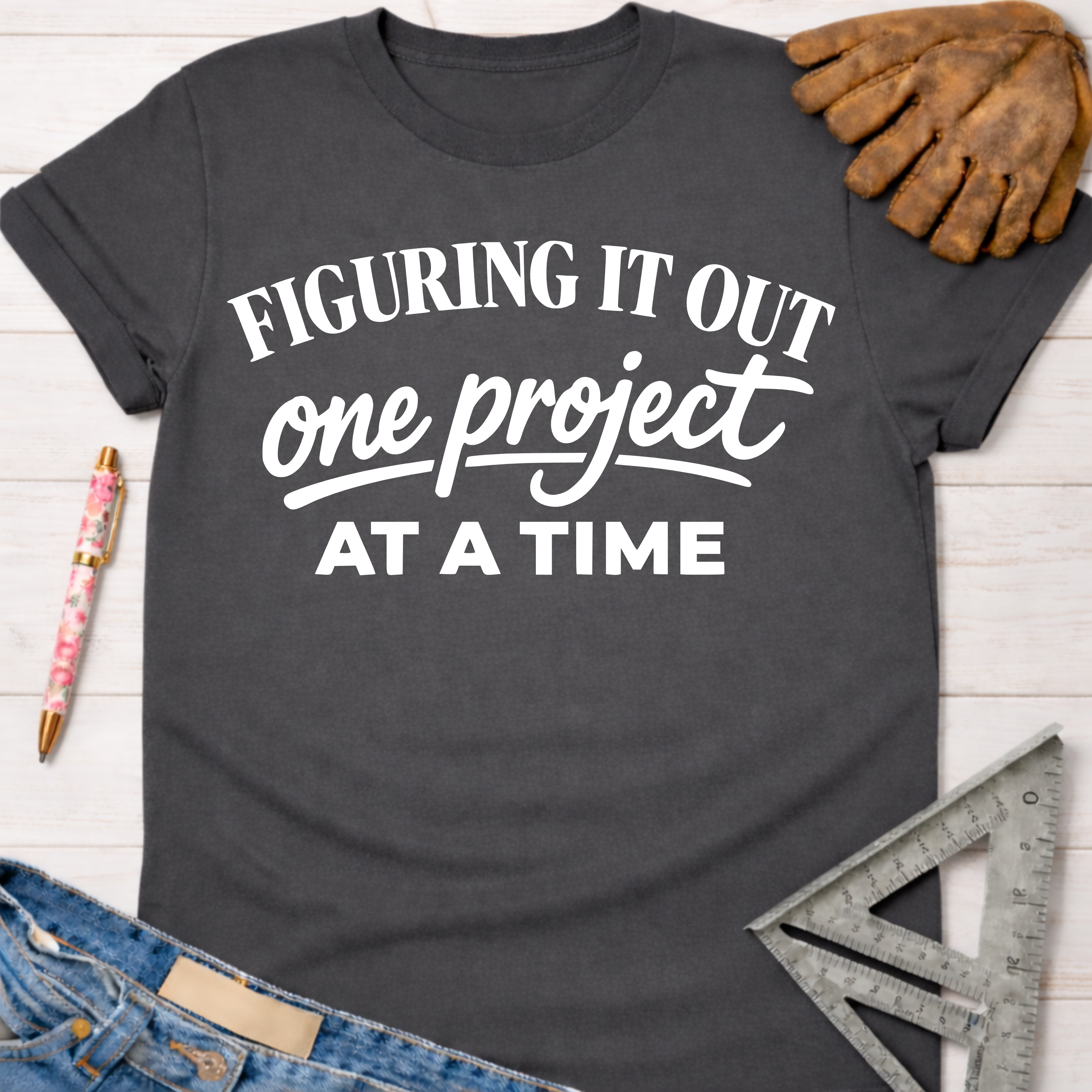 Charcoal gray cotton women's funny woodworking graphic tee shirt "Figuring It Out One Project At A Time" for female woodworkers, makers, and DIY builders — Sawdust & Ponytails