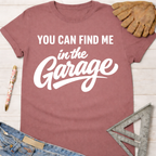 Women's funny woodworking graphic tee shirt for female woodworkers, makers, and DIY builders — Sawdust & Ponytails. Mauve pink short-sleeve t-shirt with "YOU CAN FIND ME in the Garage" in white text.