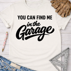 Women's funny woodworking graphic tee shirt for female woodworkers, makers, and DIY builders — Sawdust & Ponytails. White cotton tee with "You Can Find Me In The Garage" in black script.