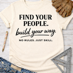 Women's funny woodworking graphic tee shirt for female woodworkers, makers, and DIY builders — Sawdust & Ponytails. Cream t-shirt with "FIND YOUR PEOPLE. build your way. NO RULES. JUST SKILL." text.