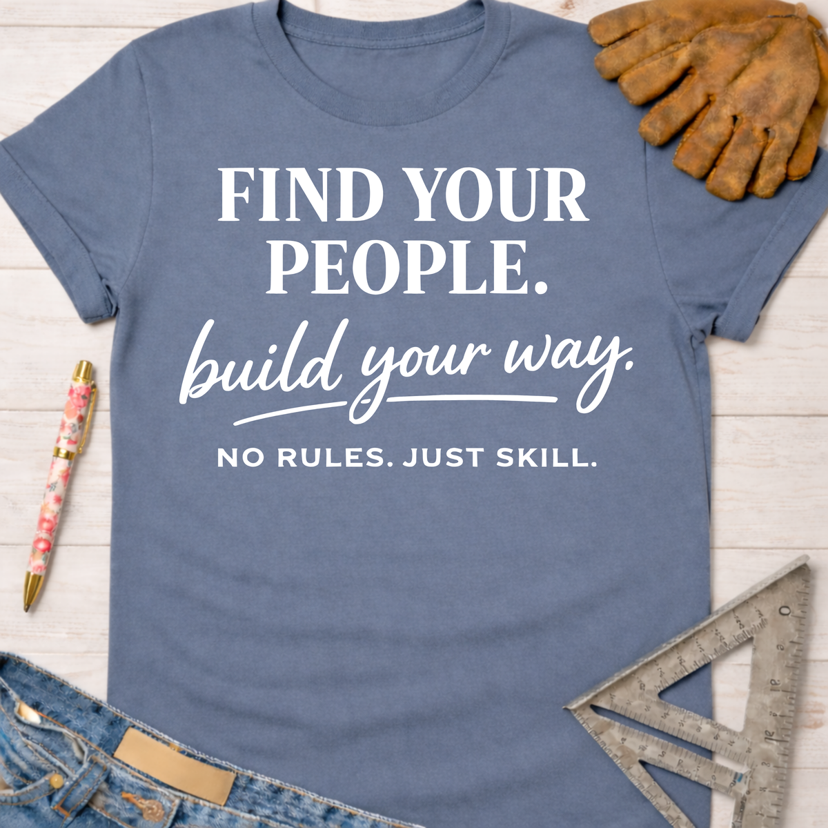 Women's funny woodworking graphic tee shirt for female woodworkers, makers, and DIY builders — Sawdust & Ponytails. Blue cotton tee with "Find Your People. build your way. NO RULES. JUST SKILL." text.