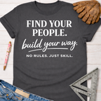 Women's funny woodworking graphic tee shirt for female woodworkers, makers, and DIY builders — Sawdust & Ponytails. Dark gray cotton tee with "FIND YOUR PEOPLE. build your way. NO RULES. JUST SKILL." in white text.