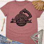 Women's funny woodworking graphic tee shirt for female woodworkers, makers, and DIY builders — Sawdust & Ponytails. Mauve t-shirt with black floral engraved circular saw graphic.
