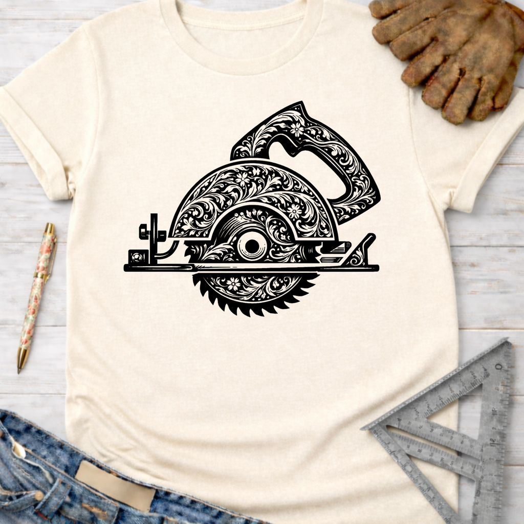 Women's funny woodworking graphic tee shirt for female woodworkers, makers, and DIY builders — Sawdust & Ponytails. Cream t-shirt with a black floral engraved circular saw design.