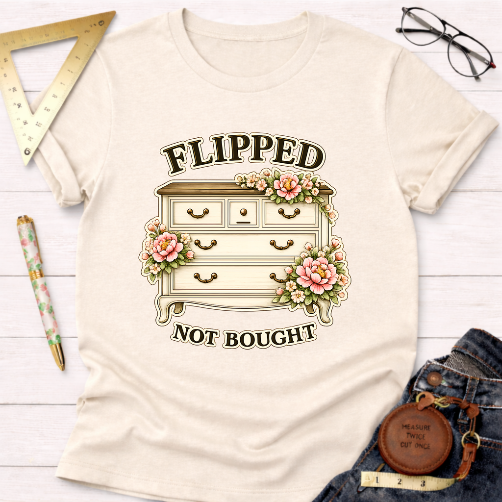 Cream t-shirt with "Flipped Not Bought" text and a floral decorated dresser graphic.