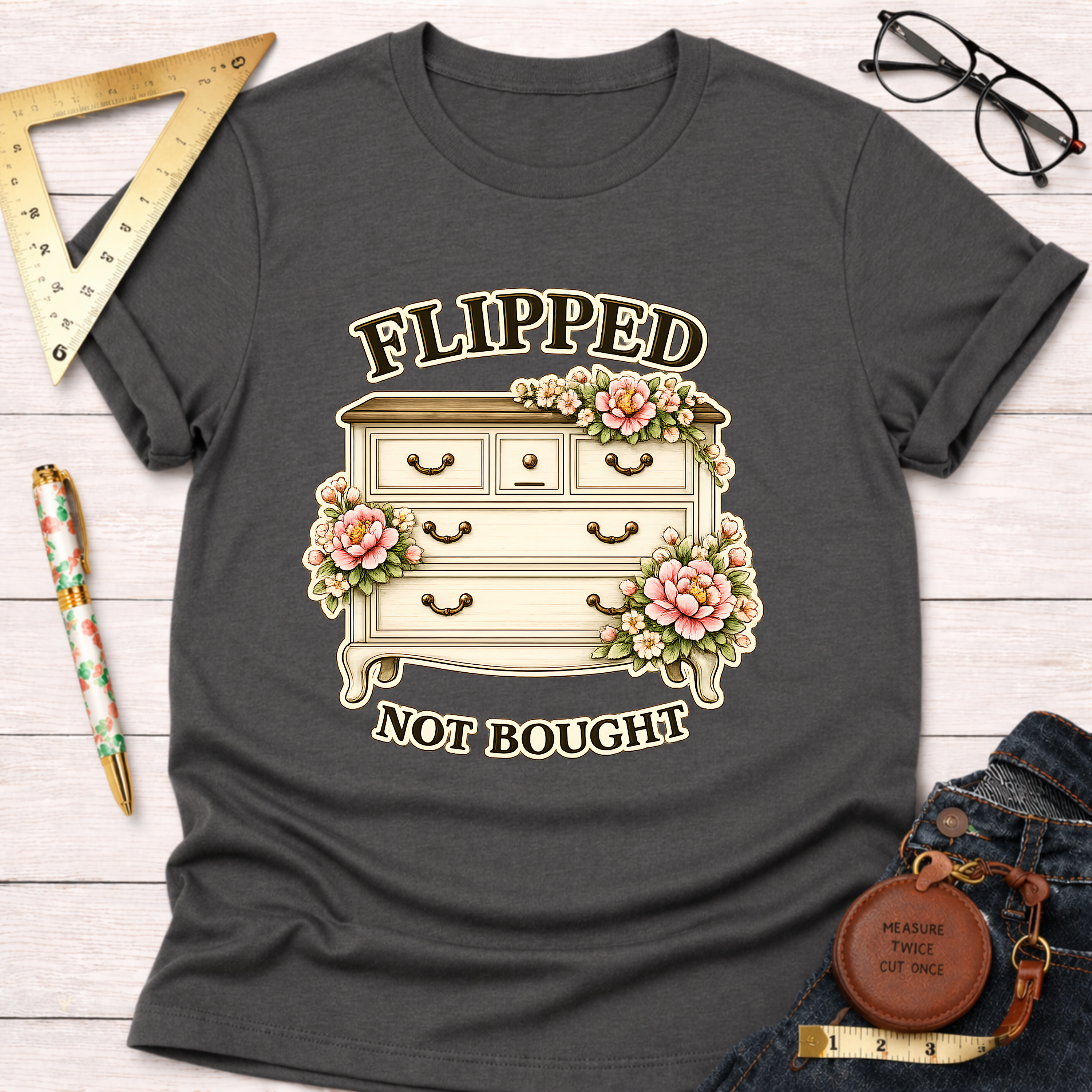 Charcoal gray "Flipped Not Bought" t-shirt with a vintage dresser and pink floral design.