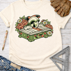 Women's funny woodworking graphic tee shirt for female woodworkers, makers, and DIY builders — Sawdust & Ponytails. Cream t-shirt with a colorful floral table saw graphic.