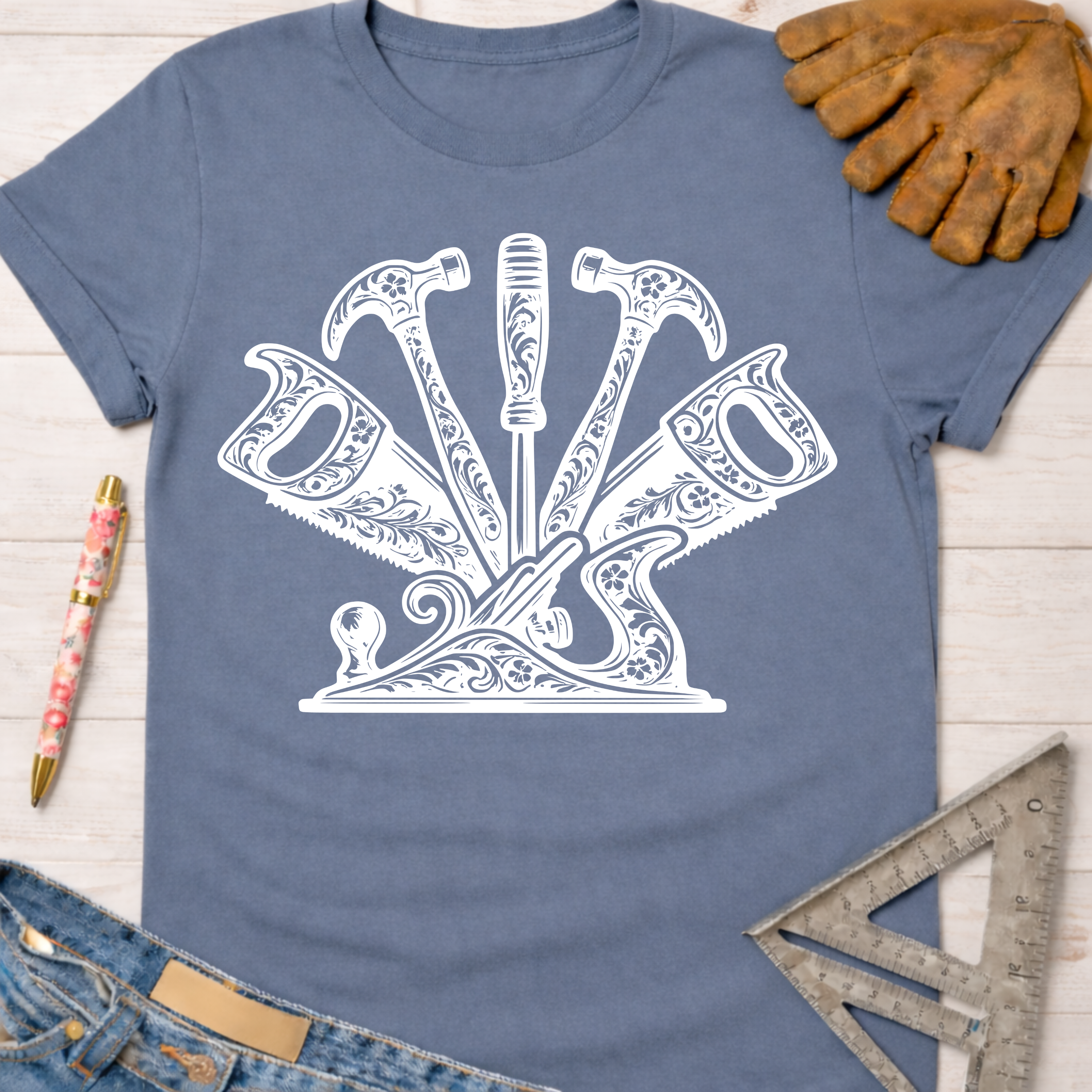 Women's funny woodworking graphic tee shirt for female woodworkers, makers, and DIY builders — Sawdust & Ponytails. Blue cotton tee with white floral tool graphic.