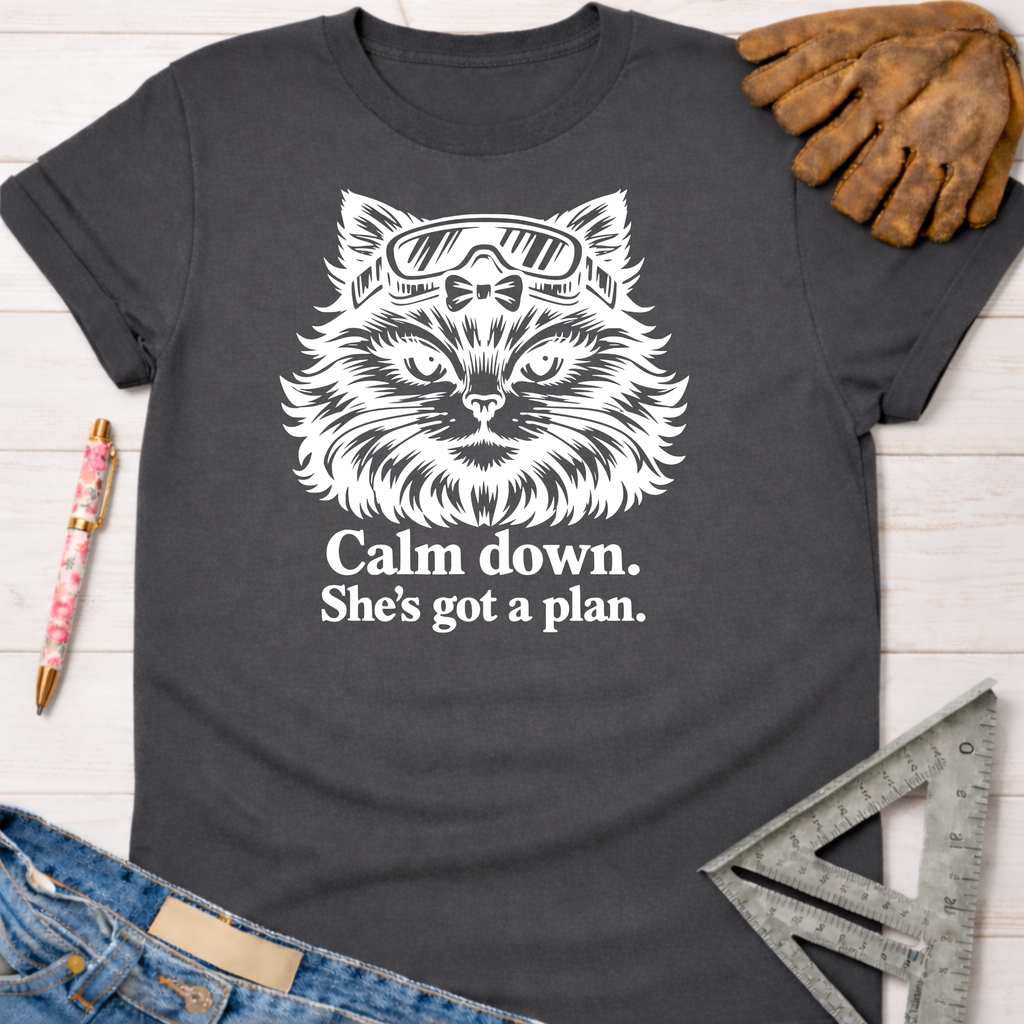 Charcoal gray Gato With A Plan T-Shirt with white cat graphic wearing goggles, "Calm down. She's got a plan." text. Women's funny woodworking graphic tee shirt for female woodworkers, makers, and DIY builders — Sawdust & Ponytails