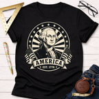 Black cotton t-shirt with a cream graphic of George Washington, "America EST. 1776," and flags.