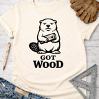 Women's funny woodworking graphic tee shirt for female woodworkers, makers, and DIY builders — Sawdust & Ponytails. Cream t-shirt with a grumpy beaver holding wood and "GOT WOOD?" text.