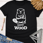Women's funny woodworking graphic tee shirt for female woodworkers, makers, and DIY builders — Sawdust & Ponytails. Black cotton tee with a white graphic of a beaver holding wood and "GOT WOOD" text.