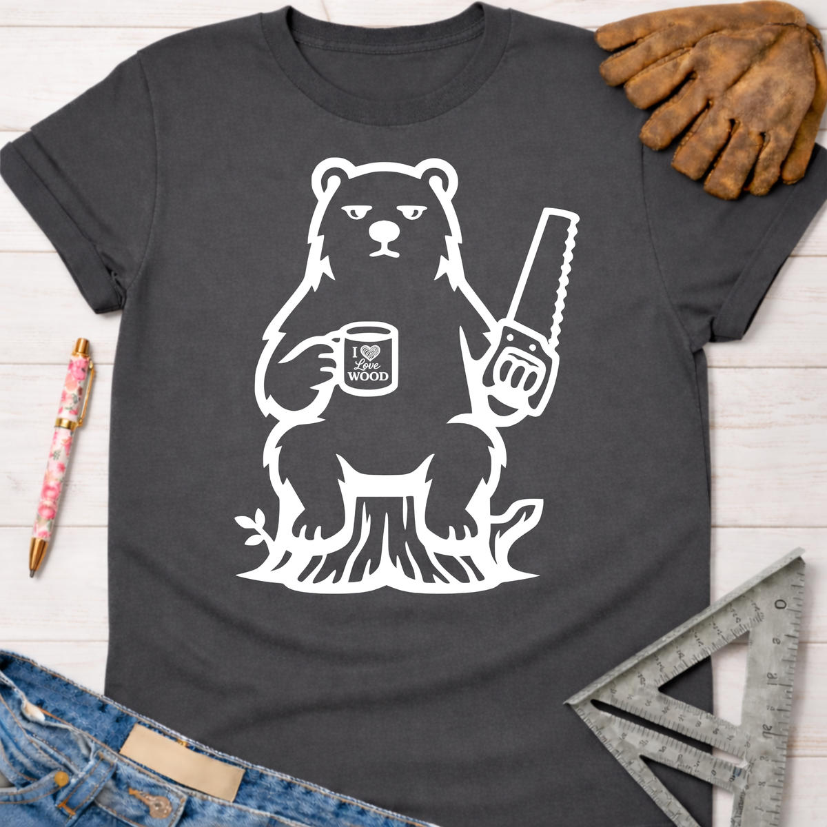 Charcoal gray women's "Grumpy Bear" graphic tee with a bear holding a saw and "I Love Wood" mug. Sawdust & Ponytails.