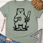 Sage green cotton Grumpy Bear t-shirt with a bear holding a saw and "I Love Wood" mug. Women's funny woodworking graphic tee shirt for female woodworkers, makers, and DIY builders — Sawdust & Ponytails