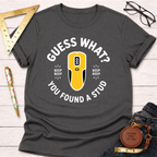 Dark gray "Guess What? You Found A Stud" t-shirt with a yellow stud finder graphic.