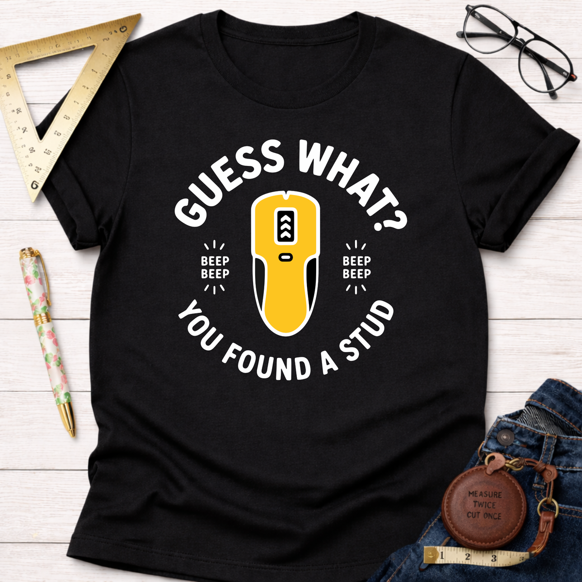 Black cotton t-shirt with "Guess What? You Found A Stud" text and a yellow stud finder graphic.
