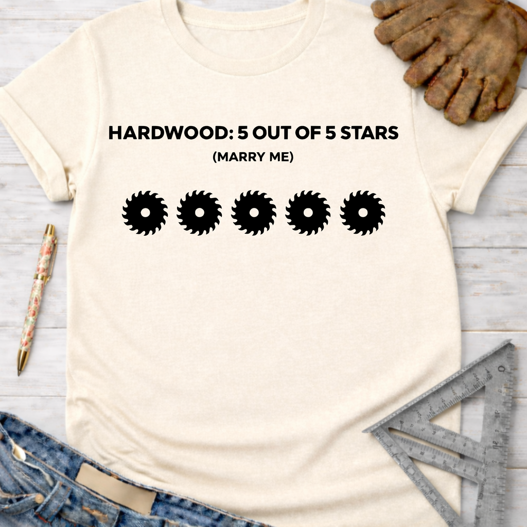Women's funny woodworking graphic tee shirt for female woodworkers, makers, and DIY builders — Sawdust & Ponytails. Cream t-shirt with "HARDWOOD: 5 OUT OF 5 STARS (MARRY ME)" text and five saw blade graphics.