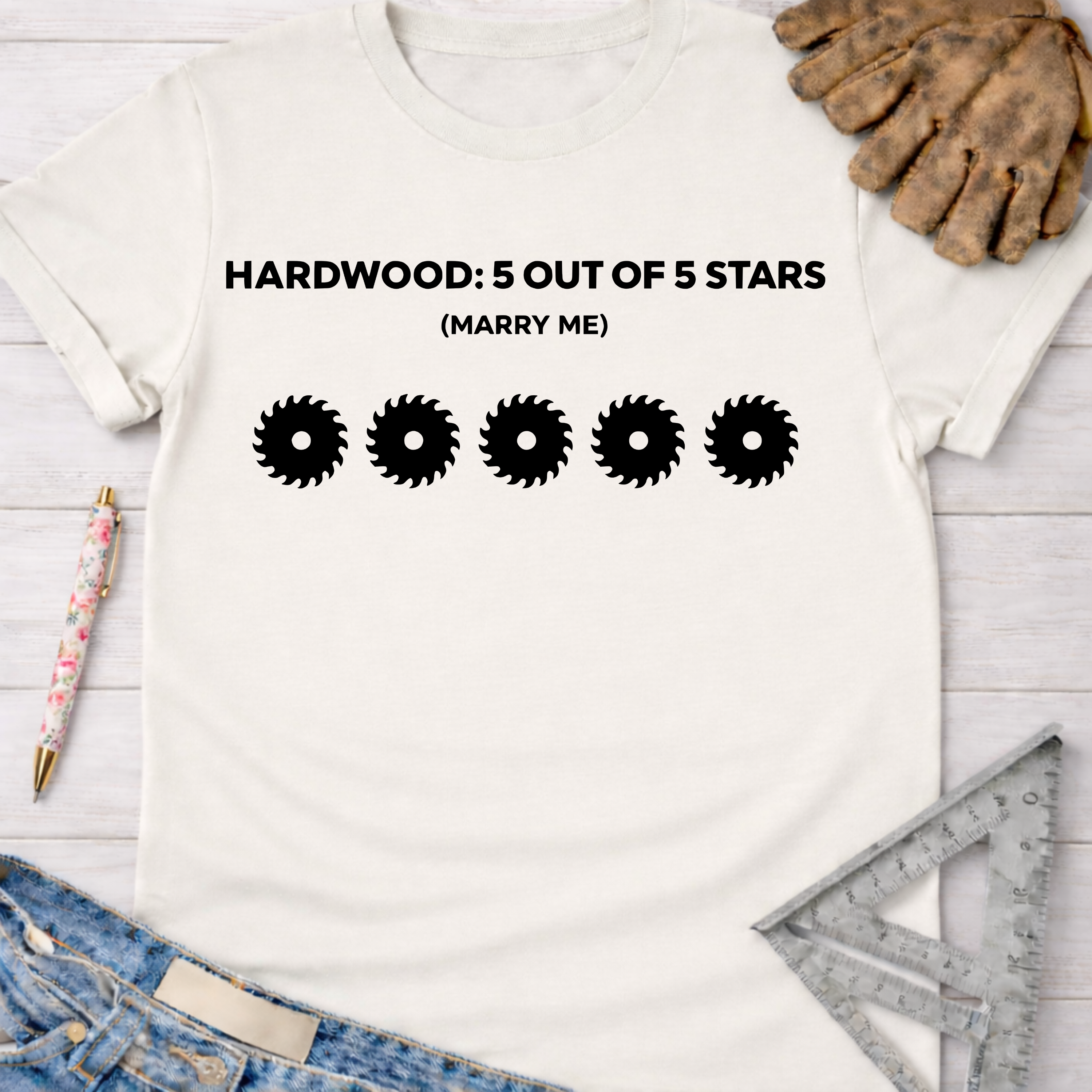 Women's funny woodworking graphic tee shirt for female woodworkers, makers, and DIY builders — Sawdust & Ponytails. White cotton tee with "HARDWOOD: 5 OUT OF 5 STARS (MARRY ME)" and five saw blade graphics.