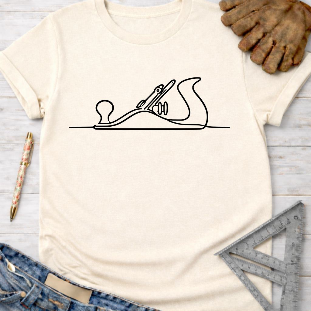 Women's funny woodworking graphic tee shirt for female woodworkers, makers, and DIY builders — Sawdust & Ponytails. Cream t-shirt with black line art hand planer design.