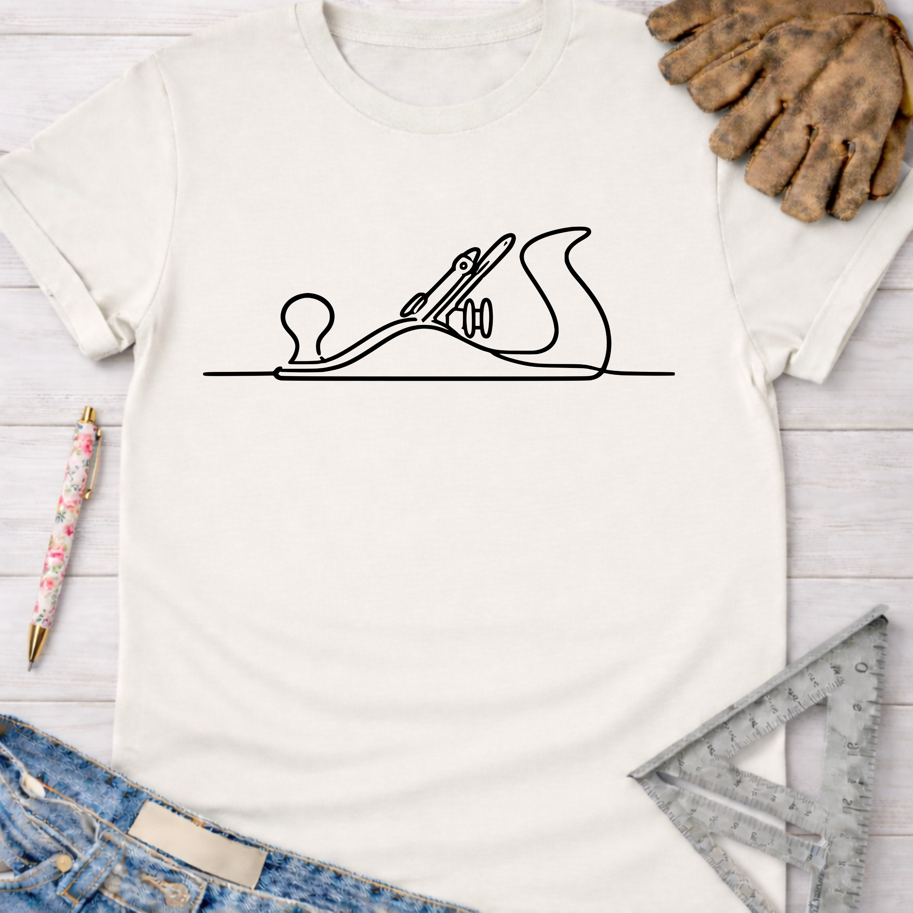 Women's funny woodworking graphic tee shirt for female woodworkers, makers, and DIY builders — Sawdust & Ponytails. White cotton t-shirt with black hand planer line art.