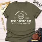 Olive green cotton t-shirt with "Handcrafted Woodwork Built Not Bought" graphic and saw blade logo.