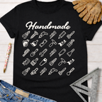 Women's funny woodworking graphic tee shirt for female woodworkers, makers, and DIY builders — Sawdust & Ponytails. Black cotton tee with "Handmade" script and white tool icons.