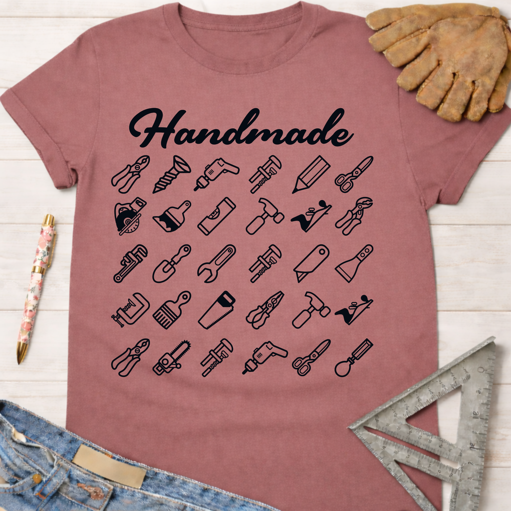 Women's funny woodworking graphic tee shirt for female woodworkers, makers, and DIY builders — Sawdust & Ponytails. Mauve t-shirt with "Handmade" and tool icons.
