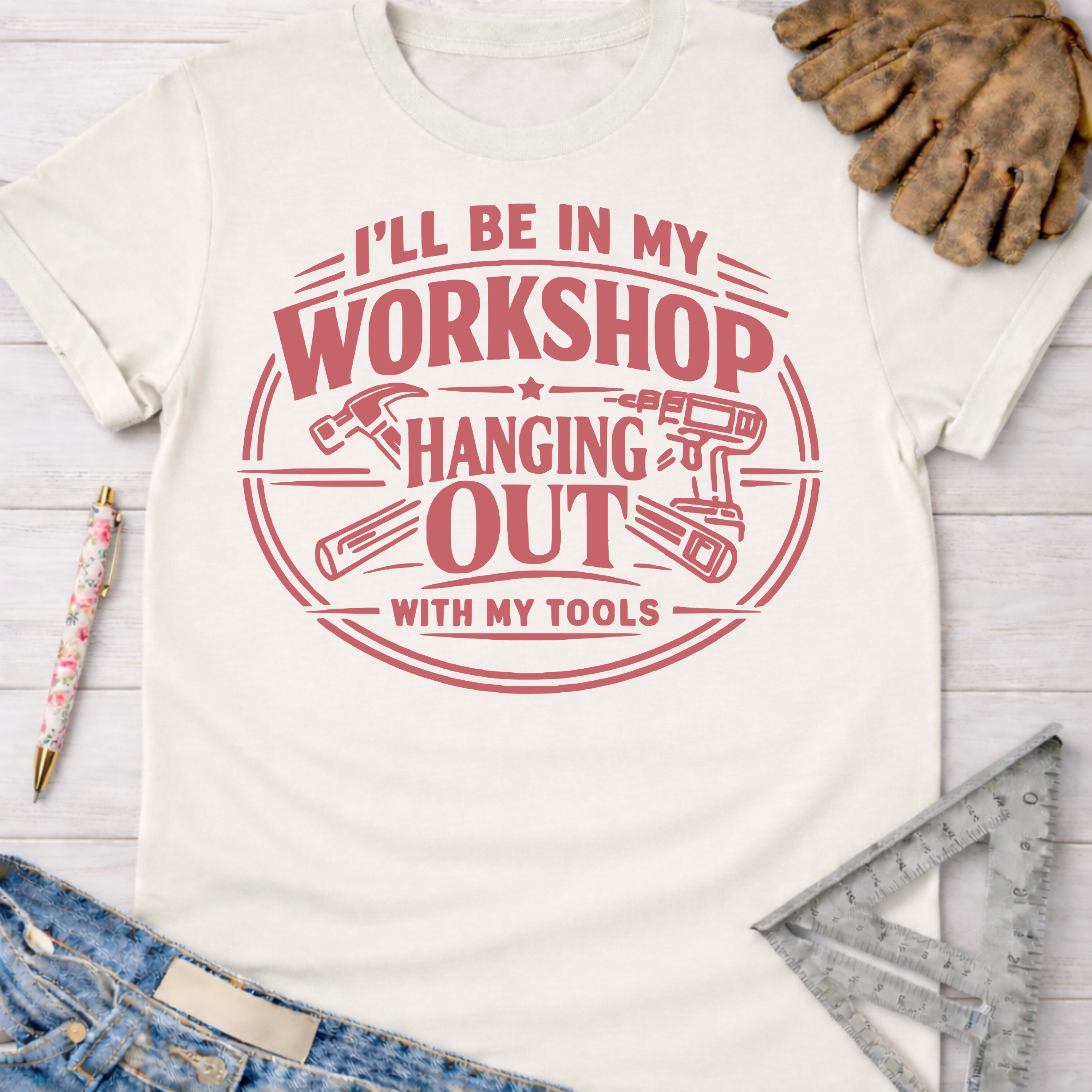 Women's funny woodworking graphic tee shirt for female woodworkers, makers, and DIY builders — Sawdust & Ponytails. Cream t-shirt with "I'll be in my workshop hanging out with my tools" graphic.